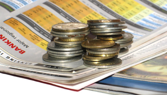 Coins lying on a newspaper