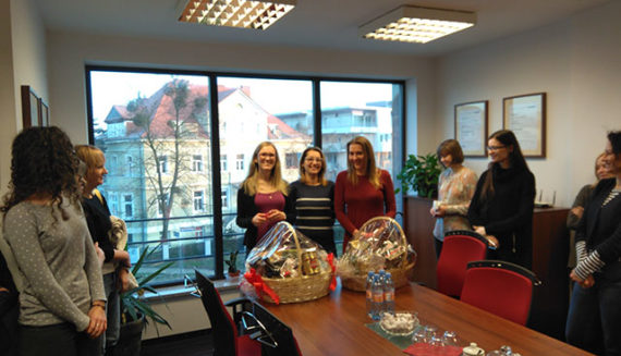 Poznan office staff celebrating 5 years of work with gift baskets