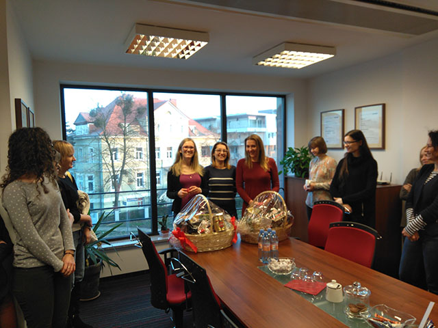 Poznan office staff celebrating 5 years of work with gift baskets