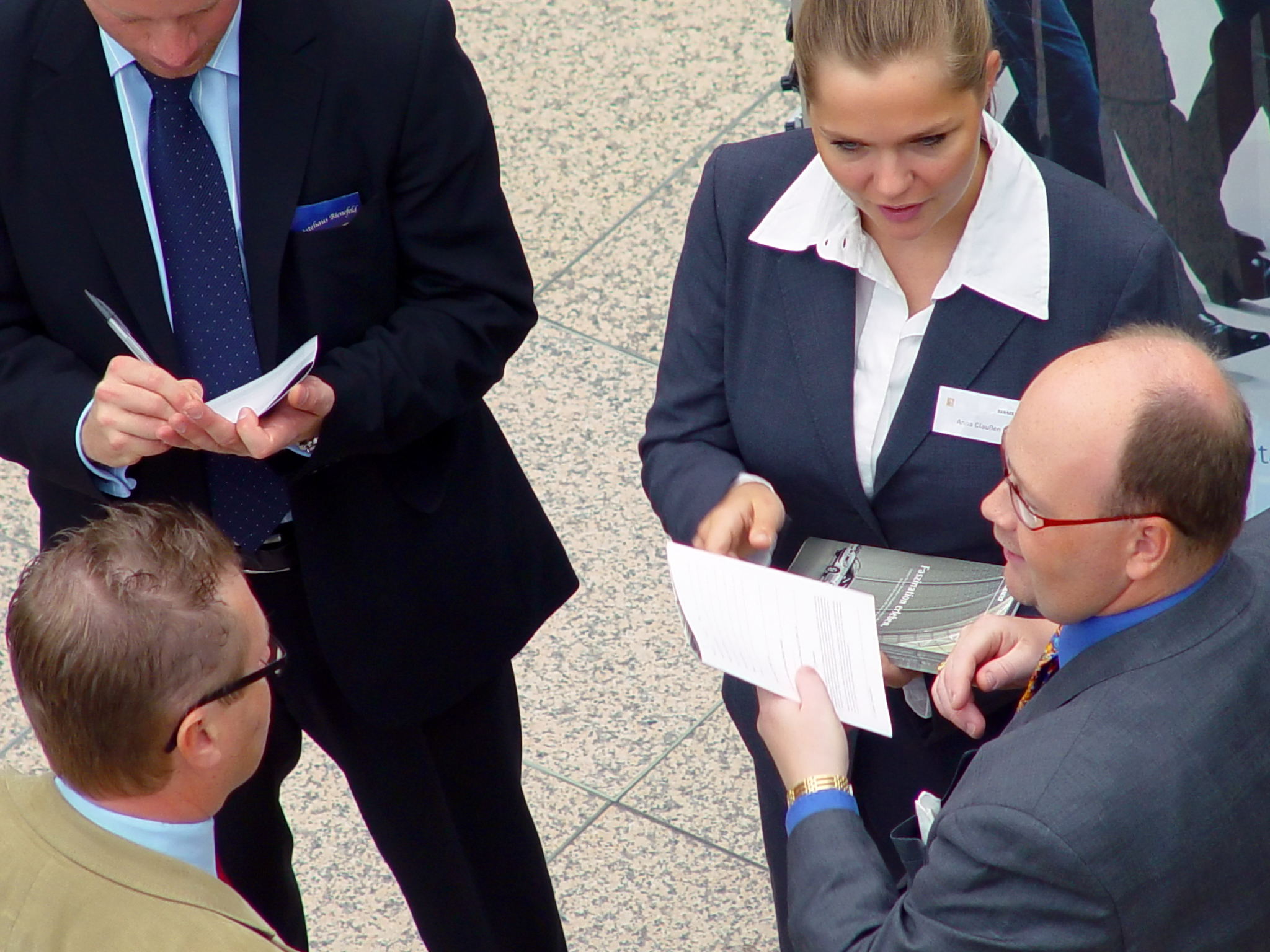 A group of people with some documents