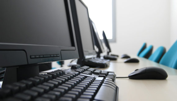 Desks with computers, keyboards and computers mouses