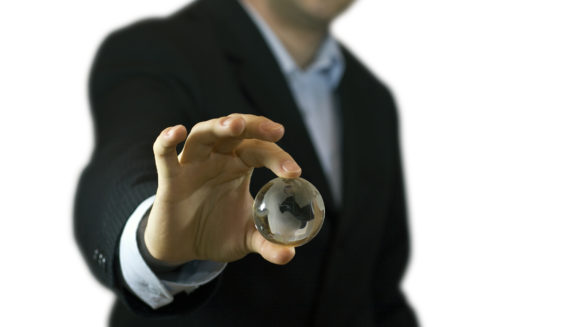 A man holding a glass ball in his hand