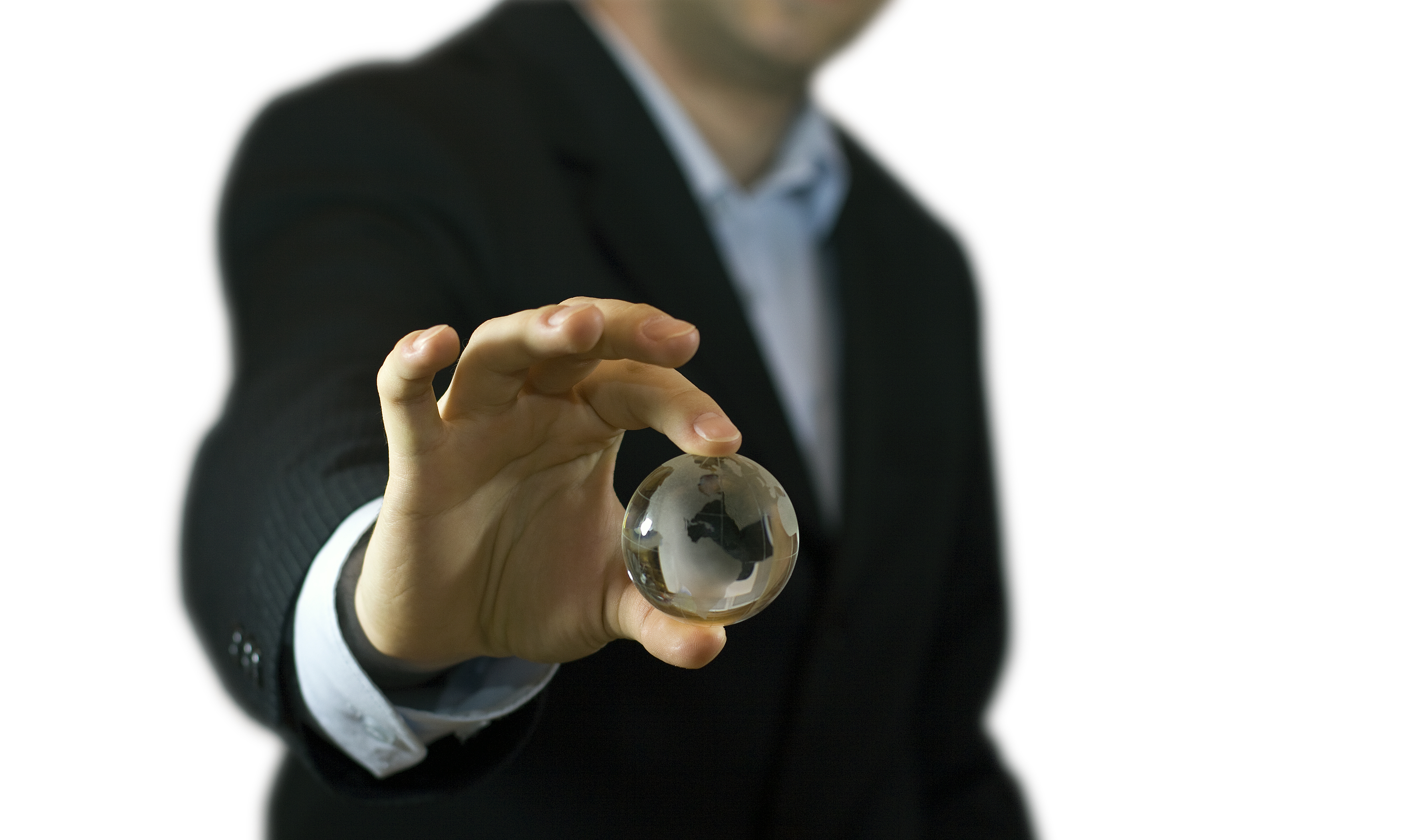 A man holding a glass ball in his hand