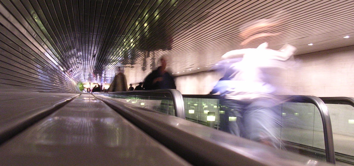 Blurry people on escalator