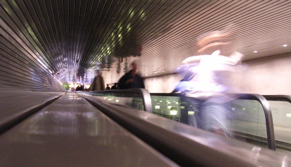 Blurry people on escalator