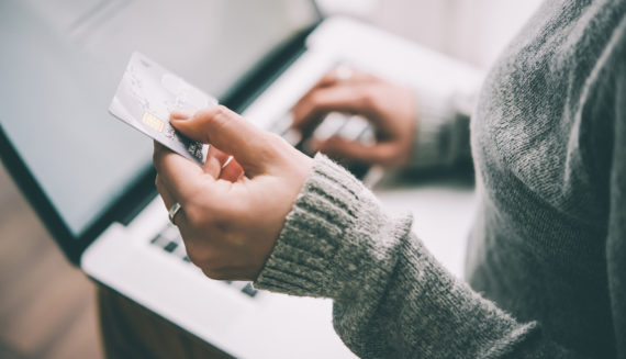 A woman holding a credit card