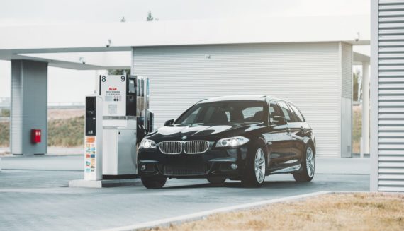 A black car at a gas station