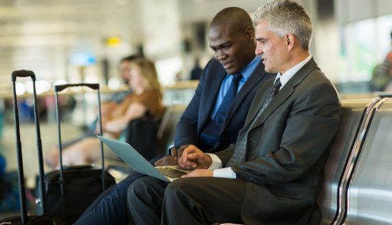 Two man in suits at the airport