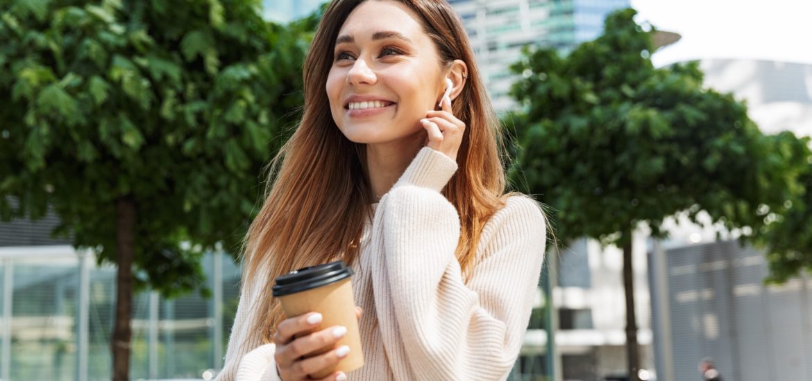 A woman having a coffee and smiling