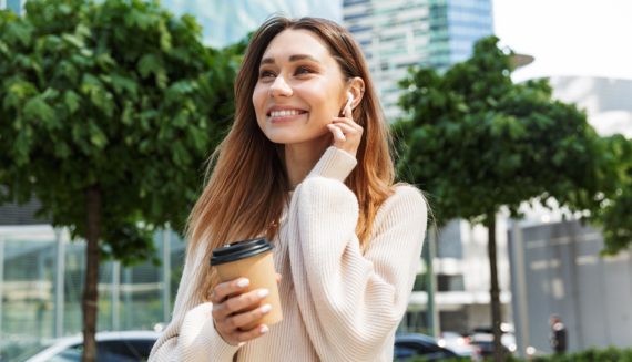 A woman having a coffee and smiling