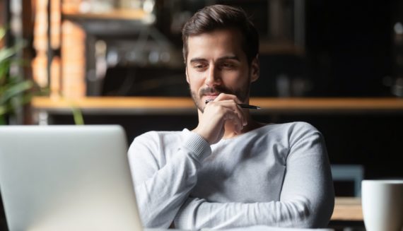 A man looking at a laptop