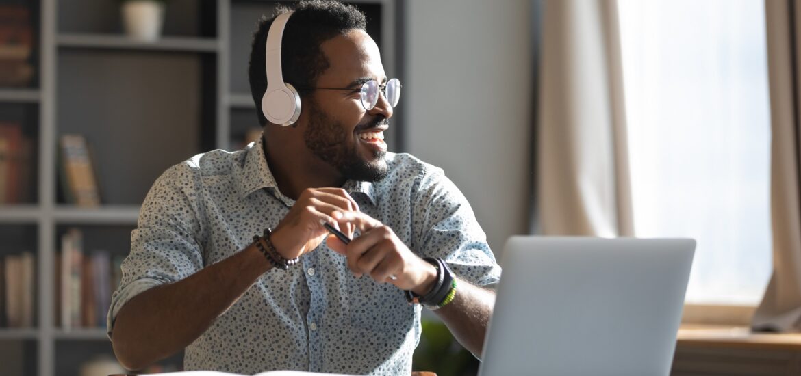 A man with headphones on laughing