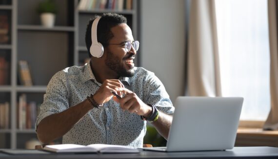 A man with headphones on laughing