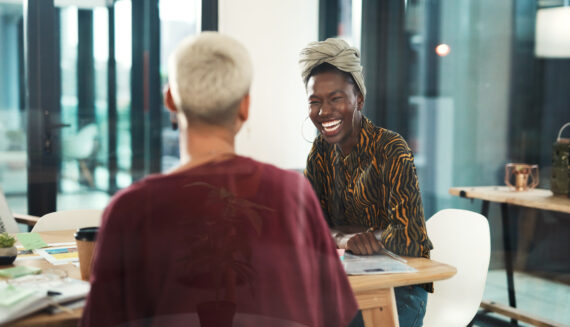 A woman sitting and laughing in the office