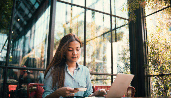 A woman looking at her credit card