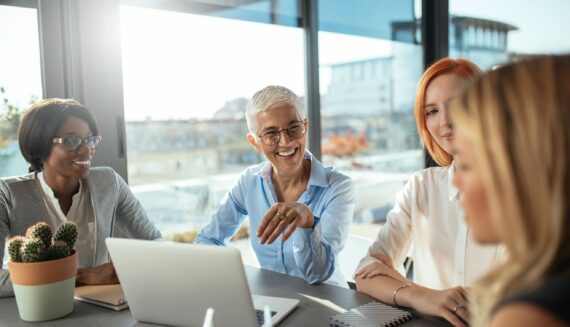 A group of people talking in an office